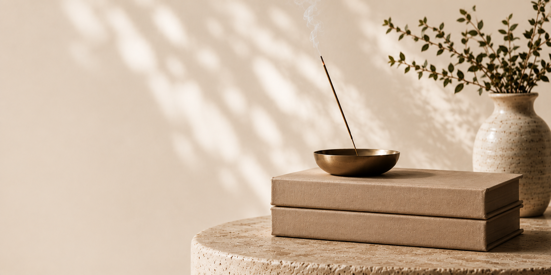 Brass incense bowl and kraft boxes on a travertine table, soft daylight